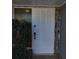 White front door with circular carvings, and glass sidelight at 14492 Tanglewood N Dr, Largo, FL 33774