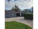 Gray house with a two car garage and circular driveway at 14492 Tanglewood N Dr, Largo, FL 33774