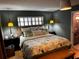Spacious main bedroom with king-size bed, floral bedding, and a leather bench at 14492 Tanglewood N Dr, Largo, FL 33774