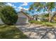 The home has a long driveway and attached garage, providing ample parking space at 15834 Glenarn Dr, Tampa, FL 33618