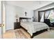 Main bedroom with a king-size bed and bay window at 1687 Starling Drive, Tarpon Springs, FL 34689