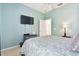 Bright bedroom featuring a TV and ensuite bathroom access at 1687 Starling Drive, Tarpon Springs, FL 34689