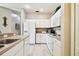 White kitchen cabinets and appliances, light flooring at 1687 Starling Drive, Tarpon Springs, FL 34689