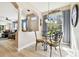 Sunlit dining area with glass table and living room access at 1687 Starling Drive, Tarpon Springs, FL 34689