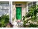 Green front door entryway with lush landscaping at 1687 Starling Drive, Tarpon Springs, FL 34689