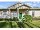 House exterior with green door, landscaping, and columns at 1687 Starling Drive, Tarpon Springs, FL 34689
