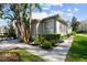 Side view of townhouse showcasing landscaping and walkway at 1687 Starling Drive, Tarpon Springs, FL 34689