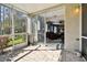 Bright screened porch with access to the living room at 1687 Starling Drive, Tarpon Springs, FL 34689