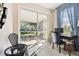 Home office with a desk and chairs, and view of backyard patio at 1687 Starling Drive, Tarpon Springs, FL 34689