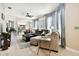 Living room with sectional sofa, light flooring, and large windows at 1687 Starling Drive, Tarpon Springs, FL 34689