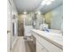 Clean bathroom, featuring a walk-in shower, toilet and updated vanity at 1687 Starling Drive, Tarpon Springs, FL 34689