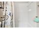 Clean bathroom with shower/tub combo and seashell-themed curtain at 1687 Starling Drive, Tarpon Springs, FL 34689