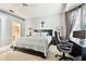 Bright bedroom with a king-size bed, workspace, and ensuite bathroom access at 1687 Starling Drive, Tarpon Springs, FL 34689