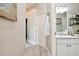 Bathroom with white vanity, and a view of a hallway at 1687 Starling Drive, Tarpon Springs, FL 34689