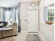Entryway with white door, light flooring, and view of living room at 1687 Starling Drive, Tarpon Springs, FL 34689