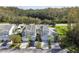 Aerial view of townhouses with two-car garages and a tree-lined street at 1687 Starling Drive, Tarpon Springs, FL 34689