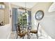Cozy dining area with glass table and wrought iron chairs at 1687 Starling Drive, Tarpon Springs, FL 34689