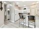 Kitchen with white cabinets, granite countertop, and breakfast bar at 1687 Starling Drive, Tarpon Springs, FL 34689