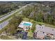 Community pool and surrounding area, including building and parking at 1687 Starling Drive, Tarpon Springs, FL 34689