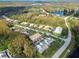 Wide aerial view of community with various housing styles and green spaces at 1687 Starling Drive, Tarpon Springs, FL 34689