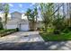 Tan house with two-car garage and walkway at 1687 Starling Drive, Tarpon Springs, FL 34689