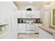 Bright kitchen with white cabinets and modern appliances at 1687 Starling Drive, Tarpon Springs, FL 34689