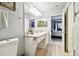 Bathroom with a vanity, toilet and view into bedroom at 1687 Starling Drive, Tarpon Springs, FL 34689