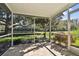 Relaxing screened porch overlooking a tranquil backyard at 1687 Starling Drive, Tarpon Springs, FL 34689