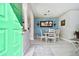 Bright dining room with white table and chairs, and blue accent wall at 1687 Starling Drive, Tarpon Springs, FL 34689