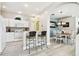 Kitchen features white cabinets, breakfast bar, and adjacent dining area at 1687 Starling Drive, Tarpon Springs, FL 34689