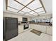 White kitchen with black appliances and a breakfast bar at 18400 Gulf Blvd # 1302, Indian Shores, FL 33785