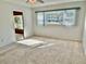 Well-lit bedroom with large window and view of the outdoors at 2284 Philippine Dr # 9, Clearwater, FL 33763