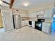 Kitchen with white cabinets, black appliances, and tile floor at 2284 Philippine Dr # 9, Clearwater, FL 33763