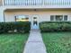 Condo building entry with walkway and landscaping at 2284 Philippine Dr # 9, Clearwater, FL 33763