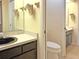 Bathroom with single sink vanity and toilet at 2460 W Marion Ave, Punta Gorda, FL 33950
