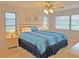 Spacious bedroom with king-size bed, nightstands, and ceiling fan at 2460 W Marion Ave, Punta Gorda, FL 33950