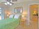 Bedroom with green bedding, wooden nightstands, and a view of the hallway at 2460 W Marion Ave, Punta Gorda, FL 33950