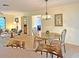 Bright dining area with a round table and four chairs, adjacent to the living room at 2460 W Marion Ave, Punta Gorda, FL 33950