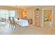 Dining room with oval table, chairs, and views into the living room and bedroom at 2460 W Marion Ave, Punta Gorda, FL 33950