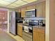 Well-equipped kitchen featuring stainless steel appliances and wood cabinetry at 2460 W Marion Ave, Punta Gorda, FL 33950