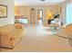 Bright living room featuring a tiled floor, yellow couch, and a view into dining area at 2460 W Marion Ave, Punta Gorda, FL 33950