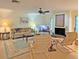 Relaxing living room featuring a fireplace, comfy seating, and a large TV at 2460 W Marion Ave, Punta Gorda, FL 33950