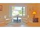 Living area with two armchairs, a coffee table, and a large window offering scenic views at 2460 W Marion Ave, Punta Gorda, FL 33950