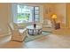Living area with two armchairs, a coffee table, and a large window offering scenic views at 2460 W Marion Ave, Punta Gorda, FL 33950