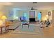 Spacious living room with a fireplace, comfy seating, and large TV at 2460 W Marion Ave, Punta Gorda, FL 33950