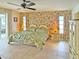 Spacious main bedroom with a large bed, floral wallpaper, and sliding door access to patio at 2460 W Marion Ave, Punta Gorda, FL 33950