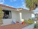 Relaxing patio with two white chairs, side table, and colorful beach towels at 2460 W Marion Ave, Punta Gorda, FL 33950