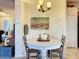 Bright breakfast nook with round table and chairs, adjacent to kitchen at 2915 126Th E Ter, Parrish, FL 34219