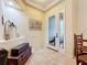 Spacious entryway with tiled floors, wooden chest, and access to the porch at 2915 126Th E Ter, Parrish, FL 34219