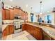 L shaped kitchen with granite countertops and wood cabinets at 2915 126Th E Ter, Parrish, FL 34219